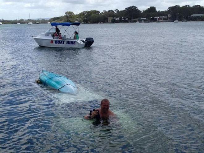 A Clayton's Towing worker tries to recover the car which has sunk near a Noosaville boat ramp.  © Geoff Potter / Sunshine Coast Daily