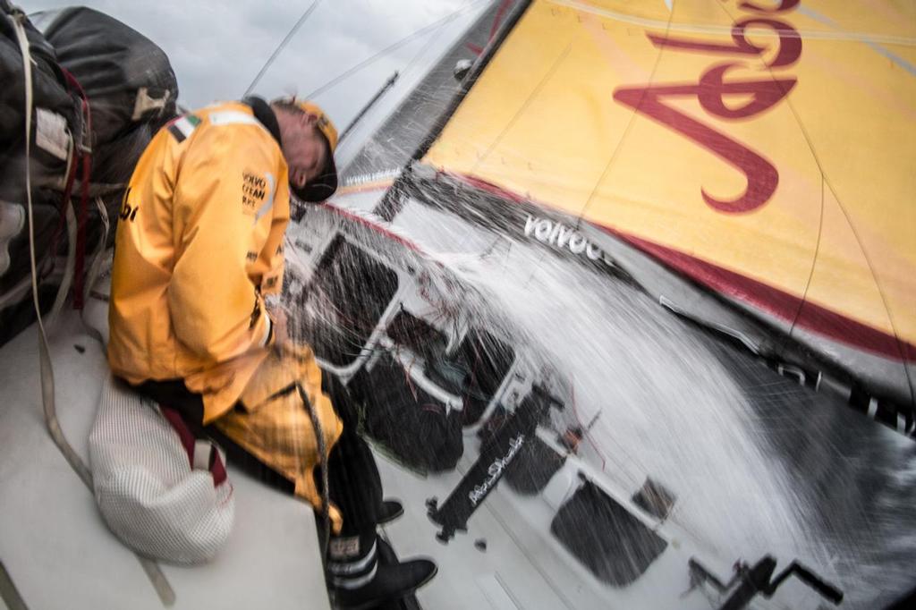 February 9, 2015. Leg 4 to Auckland onboard Abu Dhabi Ocean Racing. Day 01. Alex Higby ducks the spray of another wave as Azzam beats upwind into heavy seas. © Matt Knighton/Abu Dhabi Ocean Racing