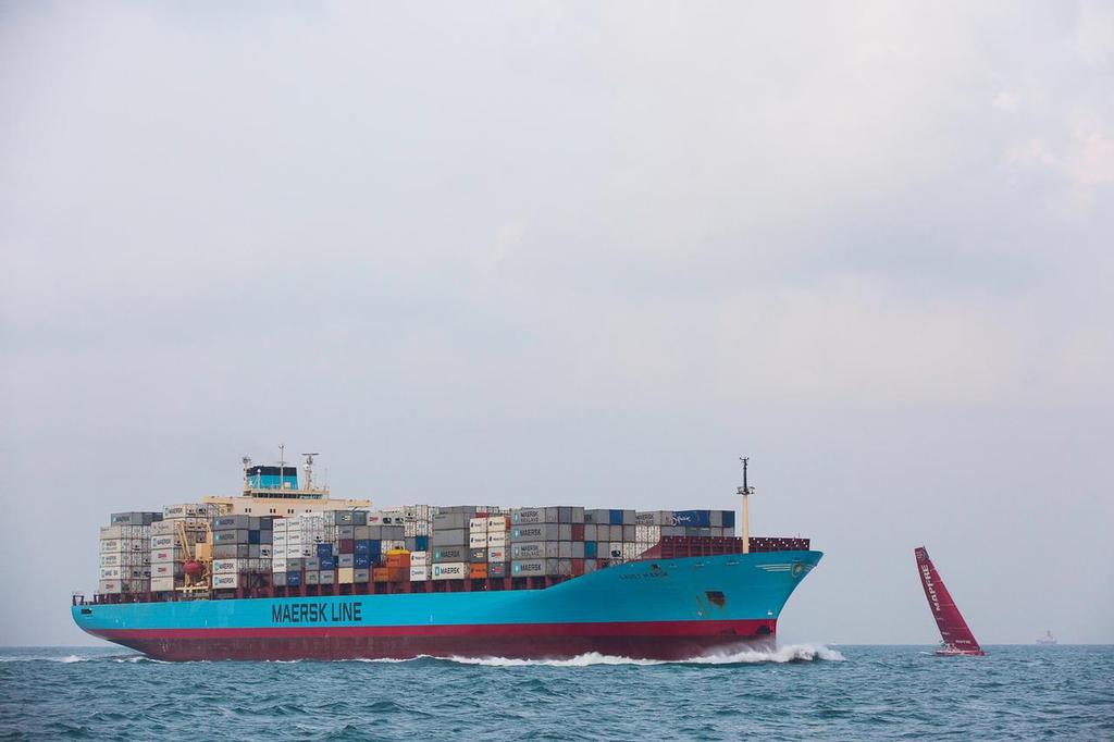 January 22, 2015. Day 19 of Leg 3 to Sanya, onboard Team Alvimedica. Through the Malacca Strait and into the busy Singapore Strait at night, with Abu Dhabi, Brunel, and Mapfre in sight. A Maersk Line cargo ship crosses close in front of Mapfre after leaving the Singapore Strait. ©  Amory Ross / Team Alvimedica