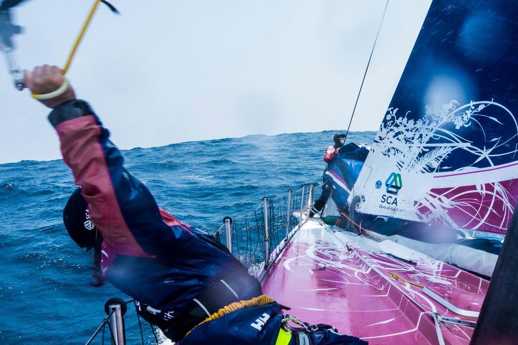 February 9, 2015. Leg 4 to Auckland onboard Team SCA. Day 1. On the bow preparing for a sail change, while the boat bounces over waves and covers the deck with water.  © Anna-Lena Elled/Team SCA