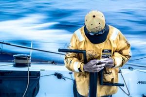 Daryl Wislang takes a look at the toll days of wet reaching has taken on his hands as the wind lets up at dusk in the Pacific Ocean - Volvo Ocean Race 2014-15 photo copyright Matt Knighton/Abu Dhabi Ocean Racing taken at  and featuring the  class