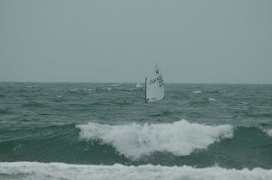 A Kiwi sailor submerges behind the swell photo copyright Fauer taken at  and featuring the  class