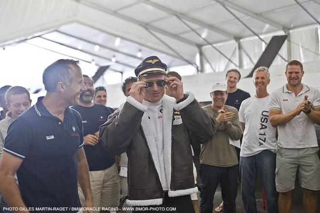 Tim Smyth (NZL) watches BOR90 helmsman Jimmy Spithill (AUS) try on his flight kit &copy; BMW Oracle Racing Photo Gilles Martin-Raget http://www.bmworacleracing.com