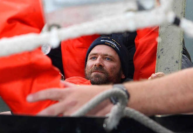 Injured French solo yachtsman, Yann Elies is lifted out of HMAS Arunta’s rigid hull inflatable boat (RHIB) and on to the ship by Able Seaman Boatswains Mate Tyron Aldrick (the bowman) and Doctor David McIlroy (Royal Flying Doctors Service). Photography by Able Seaman Photographer Lincoln Commane.<br />
<br />
 © Commonwealth of Australia