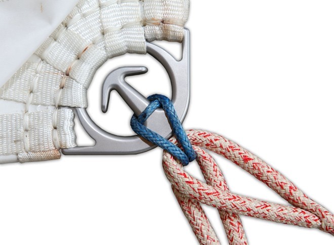 A covering flap is peeled back to allow both sheets to be quickly attached to the clew ring without the use of knots or clips. © Ivor Wilkins/Offshore Images http://www.offshoreimages.com/