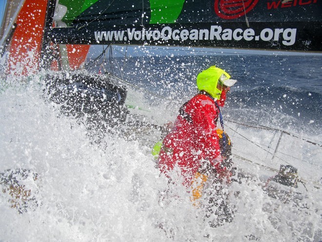 Waves wash across Green Dragon as Damian Foxall hangs onto the grinder pedestal during Leg 5 from Qingdao, China to Rio de Janeiro, Brazil.<br />
 © Guo Chuan/Green Dragon Racing/Volvo Ocean Race http://www.volvooceanrace.org