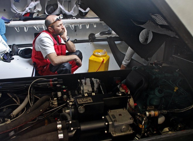 An exhausted Tom Braidwood looking at a broken generator, onboard Green Dragon, on leg 5 of the Volvo Ocean Race, from Qingdao to Rio de Janeiro © Guo Chuan/Green Dragon Racing/Volvo Ocean Race http://www.volvooceanrace.org