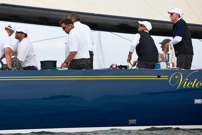 Victory ’83, sailing into Newport harbor, won The Candy Store Cup and the Modern Division of the 2009 12 Metre World Championship; owner/driver Dennis Williams (Hobe Sound, Fla./Mashpee, Mass.), with the wheel in his hands, won the 2009 12 Metre World Championship in the Modern Division © Amory Ross http://www.amoryross.com