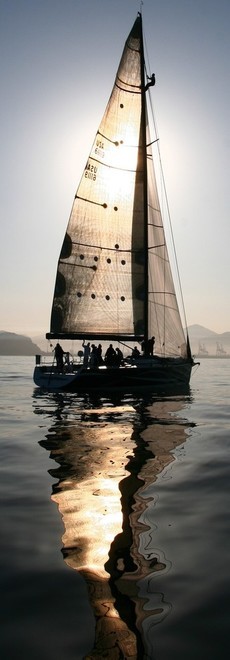 Stars & Stripes heads into the rising sun with a man up the mast  - 61st Newport to Ensenada Race  © Rich Roberts http://www.UnderTheSunPhotos.com