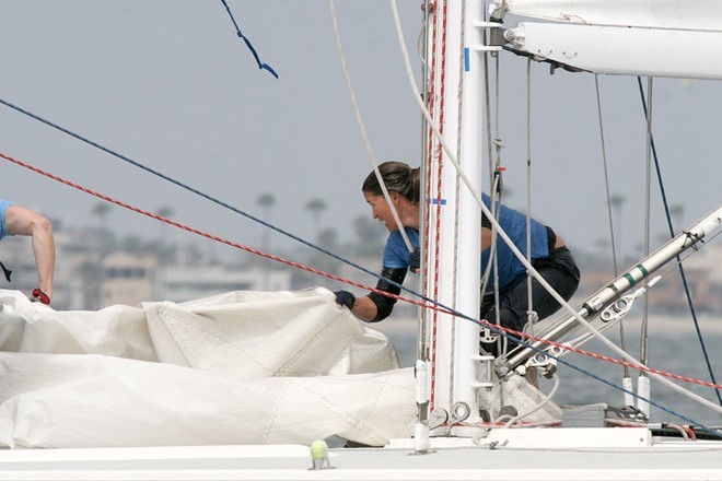The mast person for Sandy Hayes goes right back to work, soaking wet, after taking a misstep and falling overboard. - Mayor’s Cup 2007 © Sean Downey - www.blastreach.com