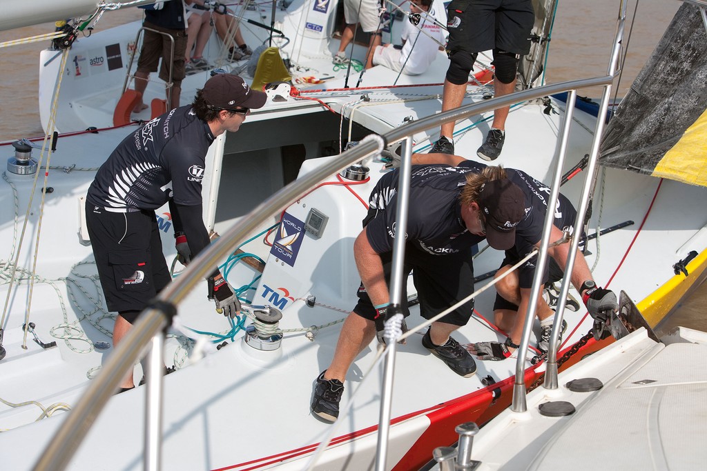 Black Match crew members push themselves off the committee boat after a pre start incident in their semi final against Peter Gilmour. Monsoon Cup 2009. Kuala Terengganu, Malaysia. 5 December 2009. Photo: Gareth Cooke/Subzero Images © Gareth Cooke Subzero Images/Monsoon Cup http://www.monsooncup.com.my