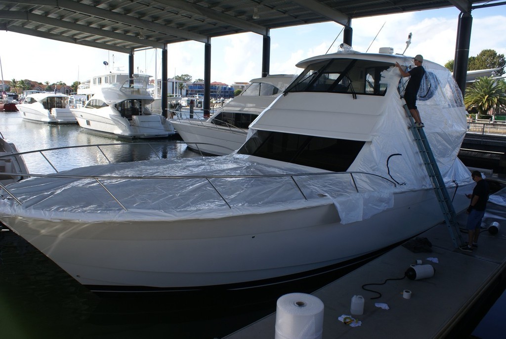 It’s a finicky and tedious task, but the heavy-duty plastic shrink-wrapping will maintain the Maritimo’s showroom appearance.  © Bob Wonders