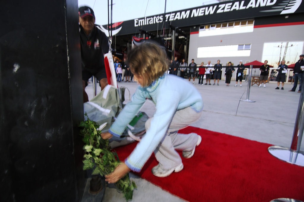 Kate Stewart lays a wreath at the foot of the flag pole at the Emirates Team New Zealand base in Valencia at a dawn ceremony for ANZAC day photo copyright Emirates Team New Zealand / Photo Chris Cameron ETNZ  taken at  and featuring the  class