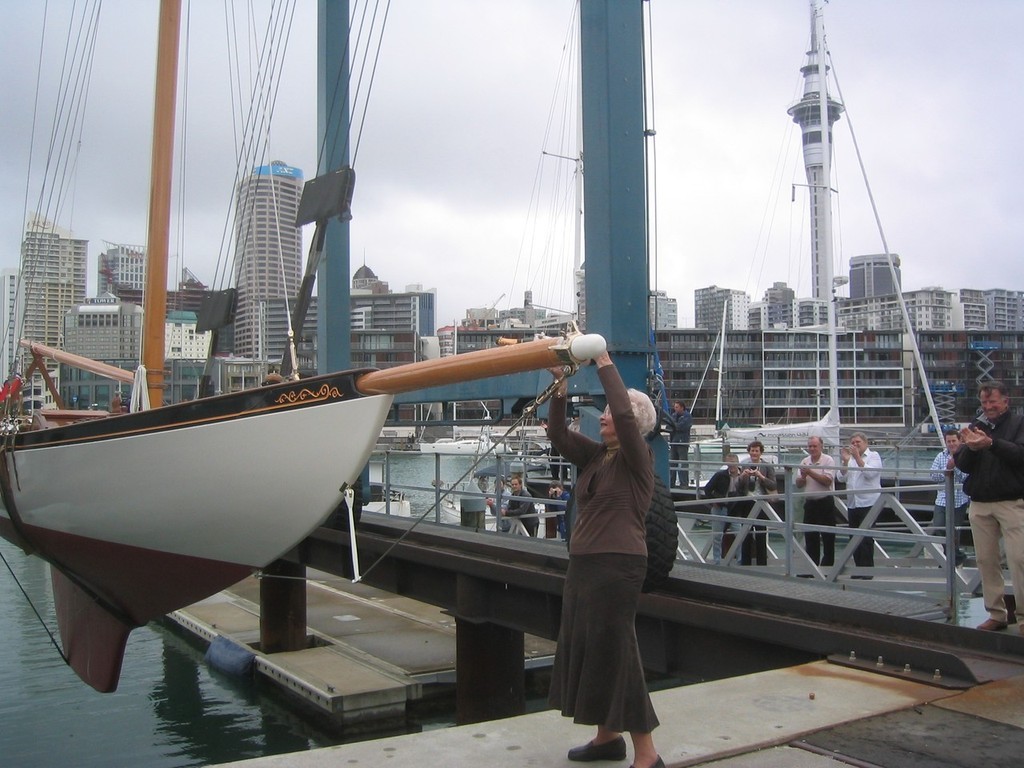 Jenny Glenn, who grew up sailing on Rainbow, rededicating the boat with a bottle of the good stuff. Jenny is Dave Glenns mother, one of the partners in the boat.<br />
<br />
 © John Bertenshaw