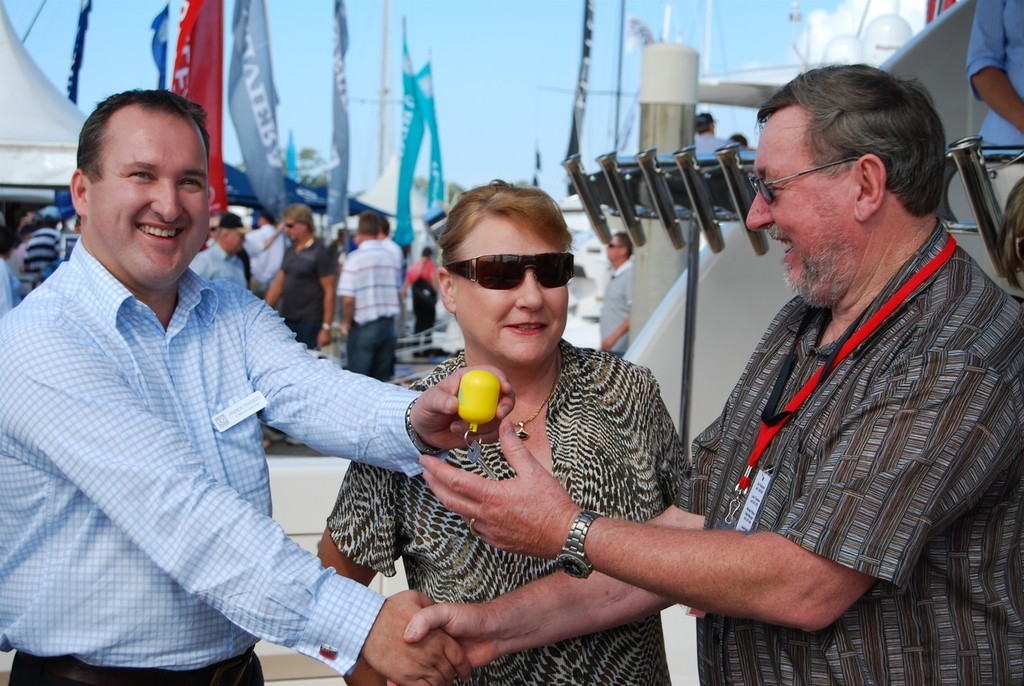 Bryan and Vicki Stokes (right) accept the keys to their new Riviera 70 from R Marine Adelaide's Andrew Craddock. - Sanctuary Cove International Boat Show photo copyright Denby Browning taken at  and featuring the  class