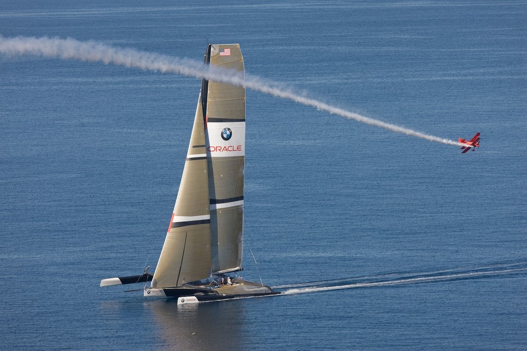 BMW ORACLE Racing - 90 ft trimaran + Oracle Team aerobatic plane photo copyright BMW Oracle Racing Photo Gilles Martin-Raget http://www.bmworacleracing.com taken at  and featuring the  class