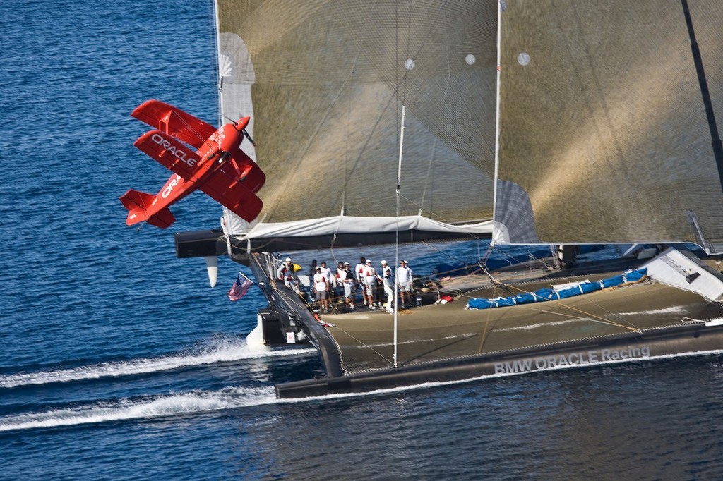 BMW ORACLE Racing - 90 ft trimaran meet  Oracle Team high performance aerobatic plane © BMW Oracle Racing Photo Gilles Martin-Raget http://www.bmworacleracing.com