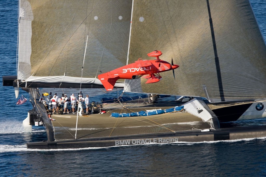 BMW ORACLE Racing - 90 ft trimaran meet Oracle Team high performance aerobatic plane © BMW Oracle Racing Photo Gilles Martin-Raget http://www.bmworacleracing.com