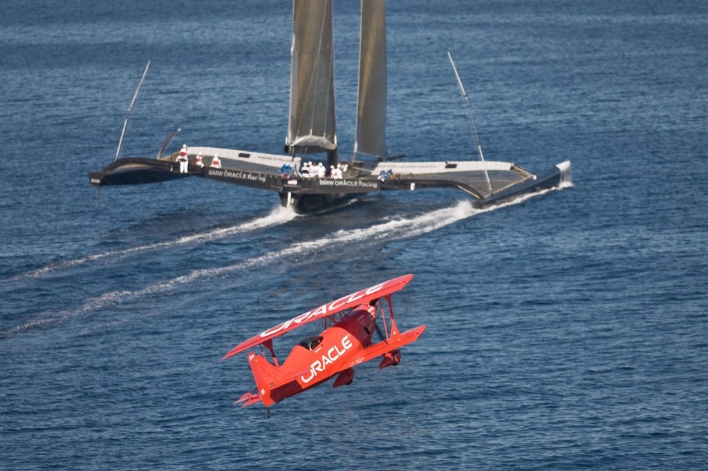 BMW ORACLE Racing - 90 ft trimaran meet  Oracle Team high performance aerobatic plane © BMW Oracle Racing Photo Gilles Martin-Raget http://www.bmworacleracing.com