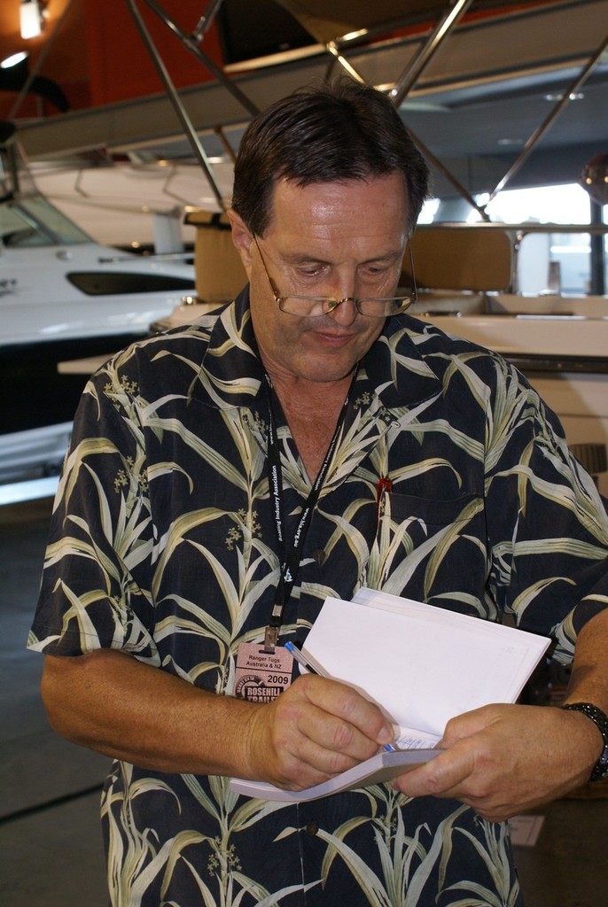 Ranger Tugs’ John Smale at Rosehill Gardens in a typical pose, that is order book and pen in hand. - Rosehill show © Bob Wonders