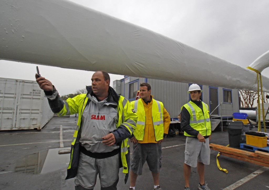 BMW Oracle Racing crew pack up the base in San Diego and the huge trimaran BOR90 is lifted by the giant RESTATE crane and slowly moved from the base to the Oceanlady freighter at the 10th street terminal to be place on the ship for the trip to Valencia, Spain.  Photo BMWOracle Racing/Bob Grieser © Bob Greiser/BMWOracle Racing www.bmworacleracing.com