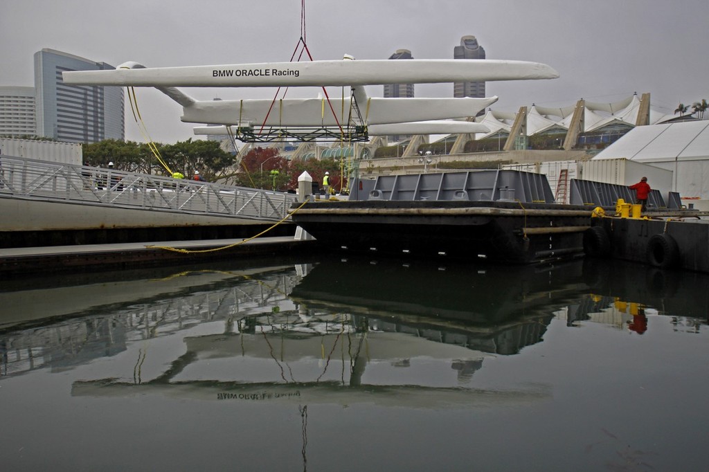 BMW Oracle Racing crew pack up the base in San Diego and the huge trimaran BOR90 is lifted by the giant RESTATE crane and slowly moved from the base to the Oceanlady freighter at the 10th street terminal to be place on the ship for the trip to Valencia, Spain.  Photo BMWOracle Racing/Bob Grieser © Bob Greiser/BMWOracle Racing www.bmworacleracing.com