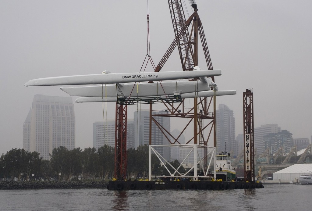 BMW Oracle Racing crew pack up the base in San Diego and the huge trimaran BOR90 is lifted by the giant RESTATE crane and slowly moved from the base to the Oceanlady freighter at the 10th street terminal to be place on the ship for the trip to Valencia, Spain.  Photo BMWOracle Racing/Bob Grieser © Bob Greiser/BMWOracle Racing www.bmworacleracing.com