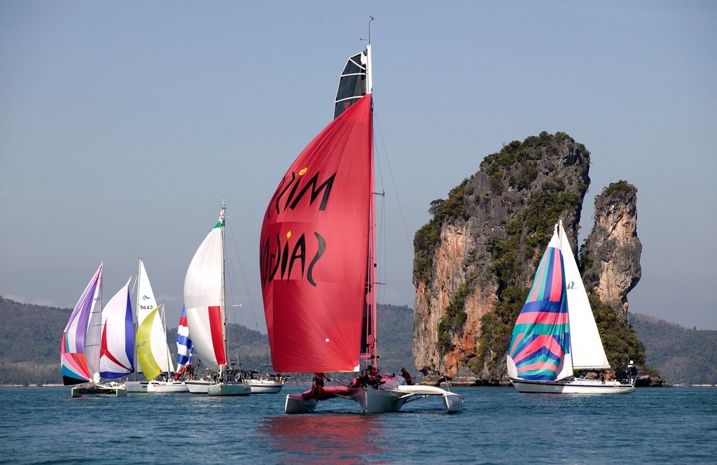 Phang Nga Bay Regatta 2010. Miss Saigon leads the way through the scenery. © Guy Nowell http://www.guynowell.com
