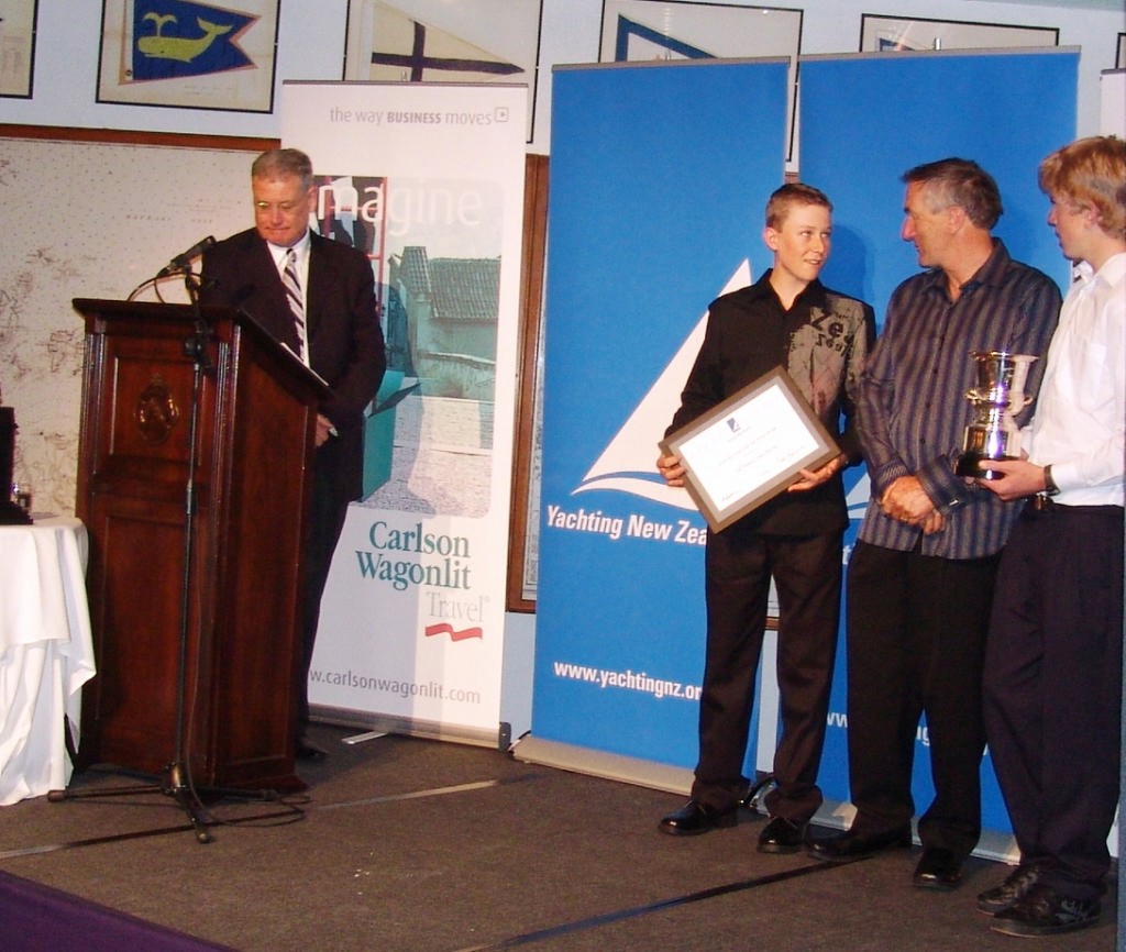 Carl Evans (left) and Peter Burling (right) with YNZ President and Olympic Gold and Silver medallist Rex Sellers (centre) © Richard Gladwell www.photosport.co.nz