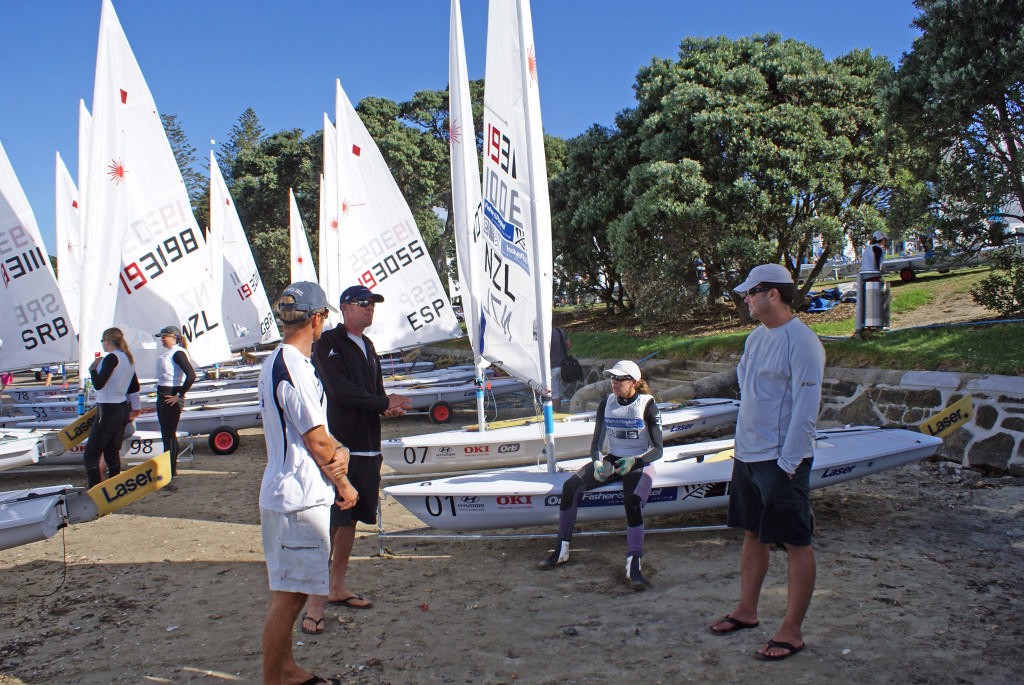 Jo Aleh debriefs with her coaching team, as they wait for race 5 to be resailed. © Richard Gladwell www.photosport.co.nz