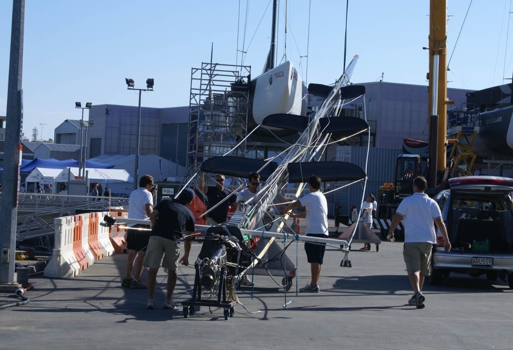 The first mast is lifted in the Louis Vuitton Village. © Richard Gladwell www.photosport.co.nz