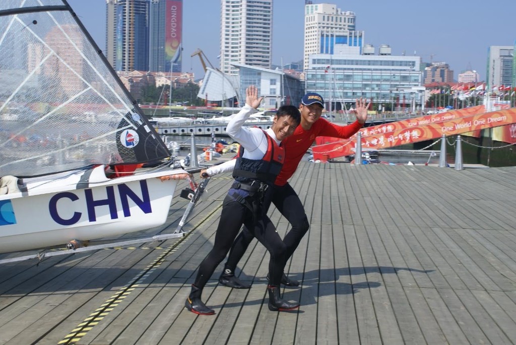 The Olympic Host 49er crew against the backdrop of Qingdao. © Richard Gladwell www.photosport.co.nz