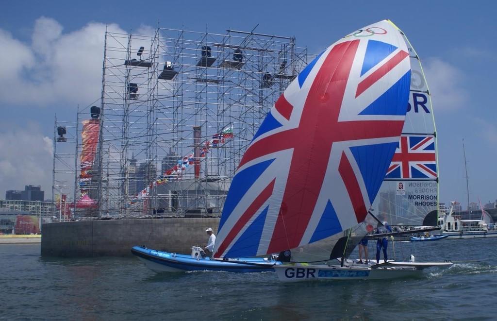 The British 48er team pass the Olympic Flame (behind the scaffolding), exiting the Olympic Harbour for the start of the 2008 Olympic Regatta  © Richard Gladwell www.photosport.co.nz