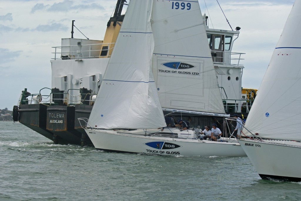 Ben Ainslie dips a molbile barge that cut very close to the action on Day 1 of the 2008 New Zealand Match Racing Championships © Richard Gladwell www.photosport.co.nz