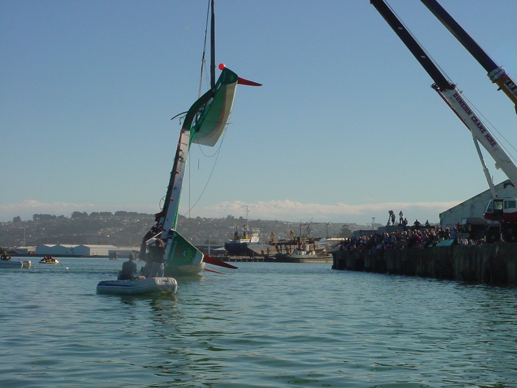 And over she goes – cranes have the weight while the Harbour Works tug pulls the main hull through below to allow the cranes to lower the vessel the right way up. photo copyright Martin Balch taken at  and featuring the  class