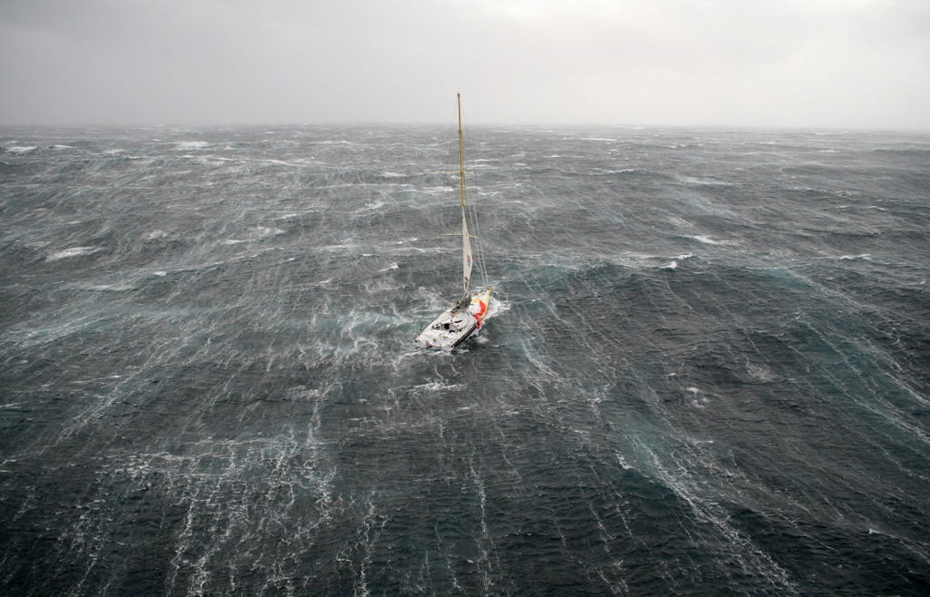 Bernard Stamm struggles in the storm on the first day of the Velux 5 Oceans Race photo copyright onEdition http://www.onEdition.com taken at  and featuring the  class