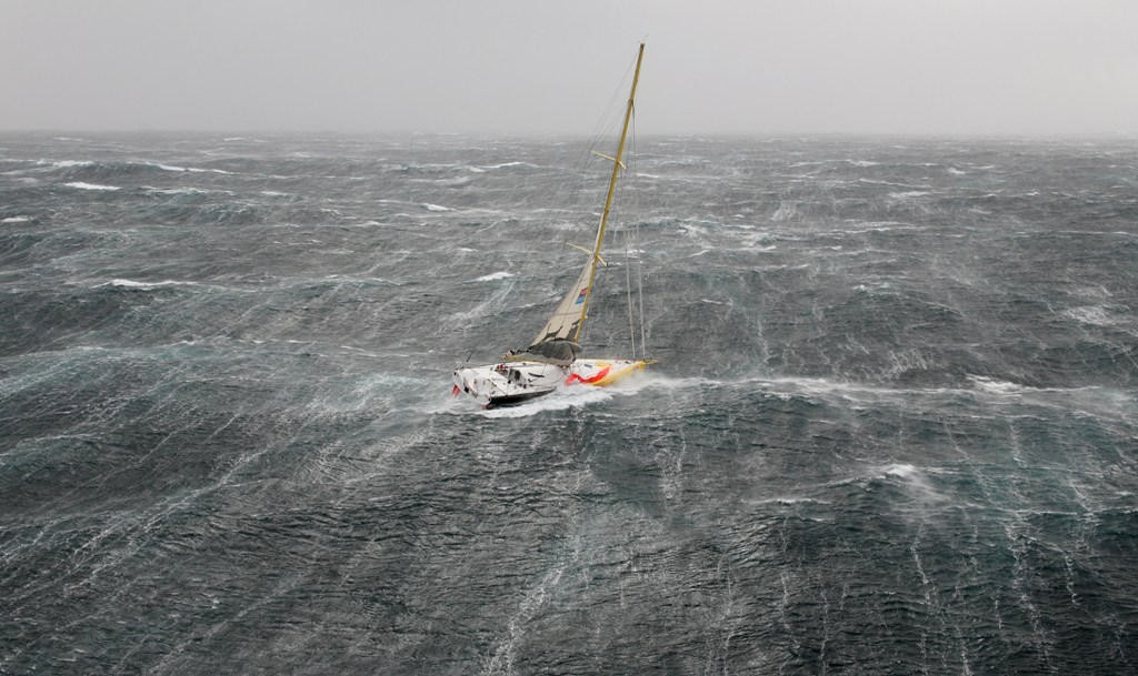 Bernard Stamm struggles in the storm on the first day of the Velux 5 Oceans Race photo copyright onEdition http://www.onEdition.com taken at  and featuring the  class