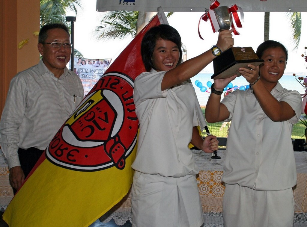 Victoria Junior College sailors Alyssa Lim (centre) & Denise Lim (right) receiving the Overall Trophy from Guest of Honour, President of Singapore Sailing Federation, Mr Low Teo Ping (left) photo copyright SingaporeSailing taken at  and featuring the  class