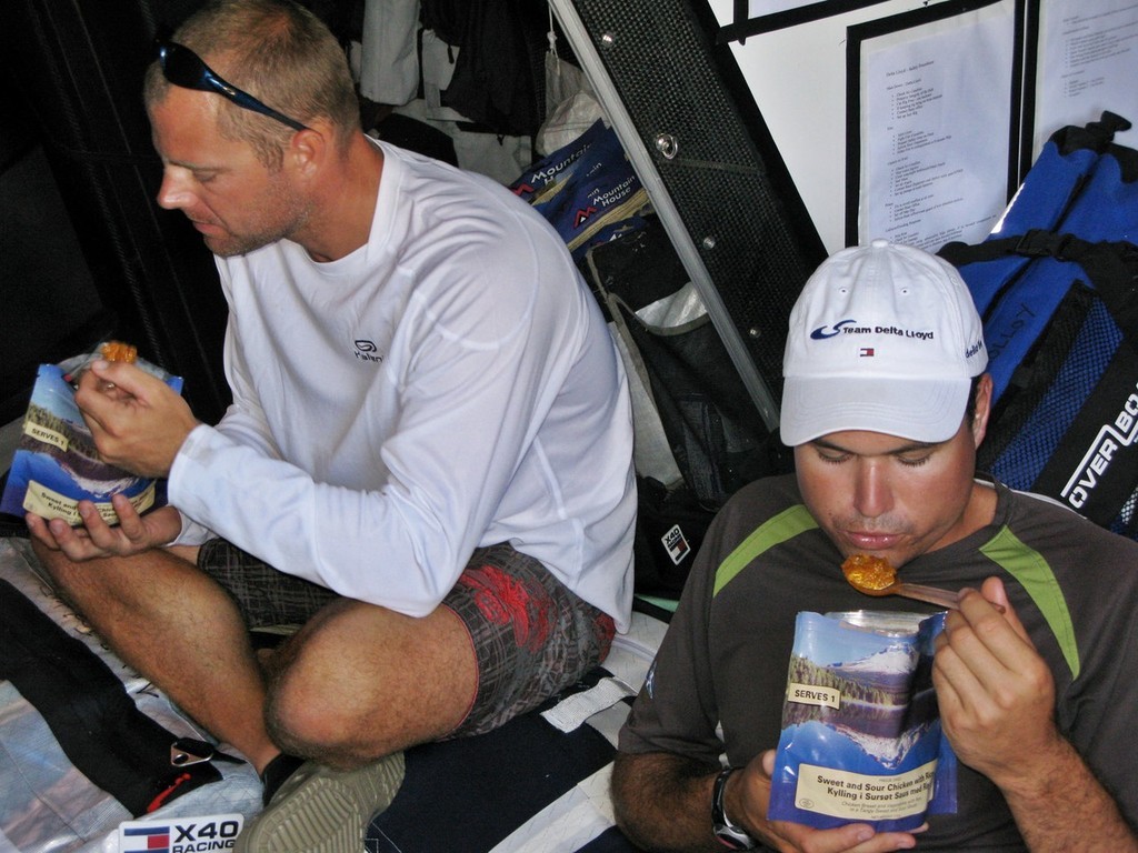 Sander Pluijm/Team Delta Lloyd: The crew of Team Delta Lloyd tuck into freeze dried sweet and sour chicken on day 5 of leg 1 of the Volvo Ocean Race<br />
<br />
 © Volvo Ocean Race http://www.volvooceanrace.com