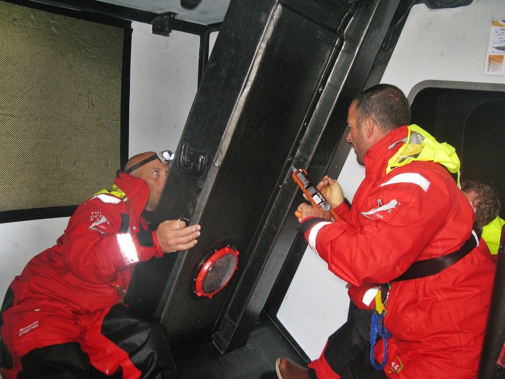 Guo Chuan/Green Dragon Racing/Volvo Ocean Race.<br />
Tom Braidwood and Damian Foxall repair a leaking daggerboard case onboard Green Dragon. © Guo Chuan/Green Dragon Racing/Volvo Ocean Race http://www.volvooceanrace.org