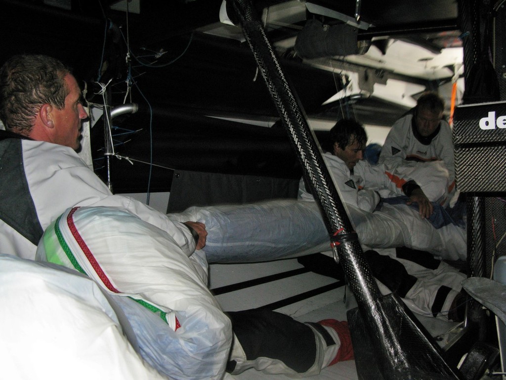 Sander Pluijm: (l-r) Peter van Niekerk, skipper Chuny and Ed O’Conner, fighting to put the spinnaker back in the snake down below the Delta Lloyd. In the middle of the night on the Southern Ocean, on leg 2 of the Volvo Ocean Race, from Cape Town, South Africa to Cochin, India © Sander Pluijm/Team Delta Lloyd/ Volvo Ocean Race http://www.volvooceanrace.org