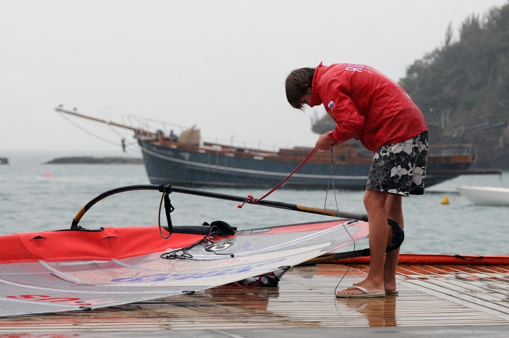 Valery Leshakov representing Russia in the Boys RS:X Windsurfer class prepares his rig in heavy rain at the Volvo Youth Sailing ISAF World Championship 2009 in Buzios, Brazil ©  David Kneale/Volvo Ocean Race http://www.volvooceanrace.com/