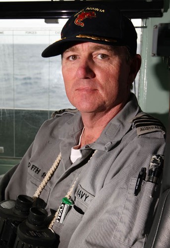 The Commanding Officer of HMAS Arunta, Commander Stephen Bowater sits in his chair on the bridge as HMAS Arunta sails towards the yacht ’Generali’, preparing to render assistance to the injured yachtsman on board. Photography by Able Seaman Photographer Lincoln Commane. © Commonwealth of Australia