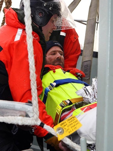 Injured French solo yachtsman, Yann Elies, is lifted out of HMAS Arunta’s rigid hull inflatable boat (RHIB) and on to the ship on a stretcher by Able Seaman Boatswains Mate Tyron Aldrick (the bowman) and Doctor David McIlroy (Royal Flying Doctors Service). Photography by Able Seaman Photographer Lincoln Commane.<br />
<br />
 © Commonwealth of Australia