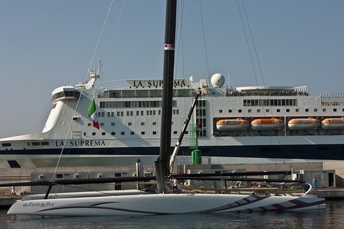 Filling the ballast tanks on Alinghi 5 would cause her to float lower in the water, or increase her 