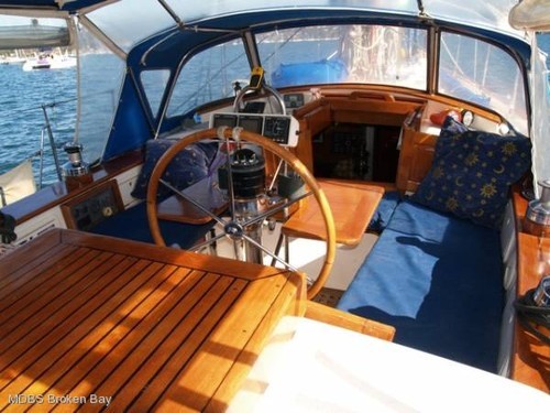 Large cockpit is fully covered and entirely enclosed by ’roll-up’ clears. Large dining table and smaller cocktail table. © BW Media