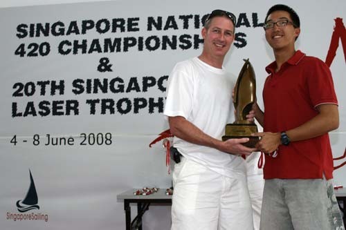 Colin Cheng (right) receiving the Singapore Laser Trophy from SingaporeSailing’s CEO Andrew Sanders. © SingaporeSailing