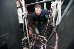 Pepe Ribes shows where the water poured in around the keel box. Volvo Open 70 Movistar has suspended racing after taking in water just before rounding Cape Horn in leg 4 of the Volvo Ocean Race. Skipper Bouwe Bekking and crew pulled in to Ushuaia and lifted the boat to repair the delamination in the keel area. © Oskar Kihlborg/ Volvo Ocean Race 2005-2006 photo copyright Volvo Ocean Race http://www.volvooceanrace.com taken at  and featuring the  class