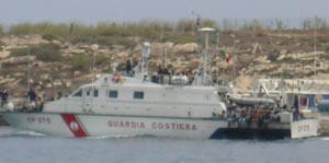Coastguard bearing asylum seekers arrives at Lampedusa © BW Media