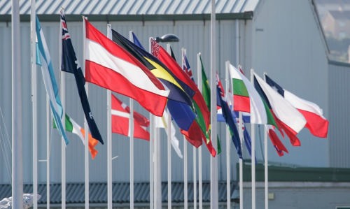 The flags of competing nations flutter limply in the light breeze. © onEdition http://www.onEdition.com
